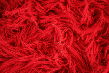 Shaggy carpet with wool material for backgrounds texture, close up of soft romantic pastel red and fluffy 