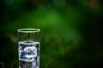 A glass of clean water with ice placed on the table ready to drink