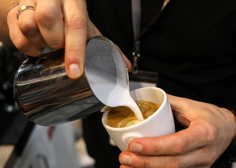 Barista making coffee at coffee machine