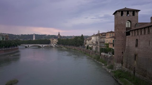 View of Bridge of the Victory in old city of Verona under cloudy grey sky in summer. Gimbal shot of view on Verona and the bridge