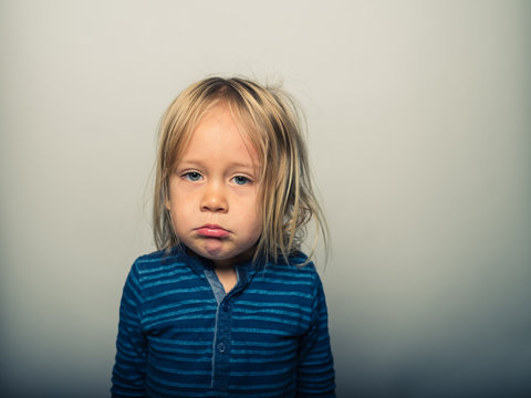 Portrait of toddler doing sad faces
