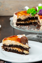 Chocolate cake with whipped cream icing on plate