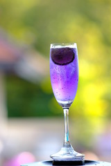 glass of cocktail on green background