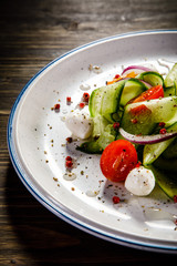 Caprese salad on wooden table