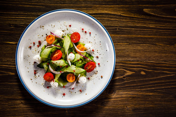 Caprese salad on wooden table