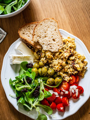 Breakfast - scrambled eggs with vegetables and toasts