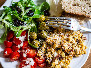 Breakfast - scrambled eggs with vegetables and toasts