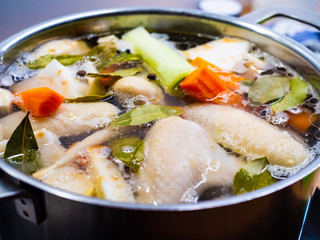 Broth - boiling chicken soup in pot 