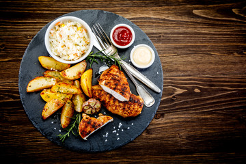Grilled chicken fillet with baked potatoes and vegetables