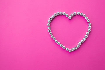 heart made of rhinestones on a pink background with text space. valentine's day layout