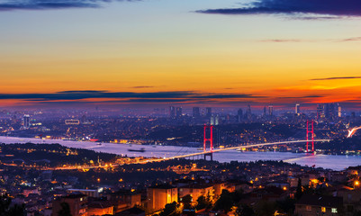 Sunset and illumination of the Bosphorus bridge and buildings of Istanbul, Turkey