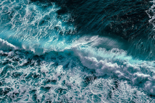Aerial view to ocean waves. Blue water background