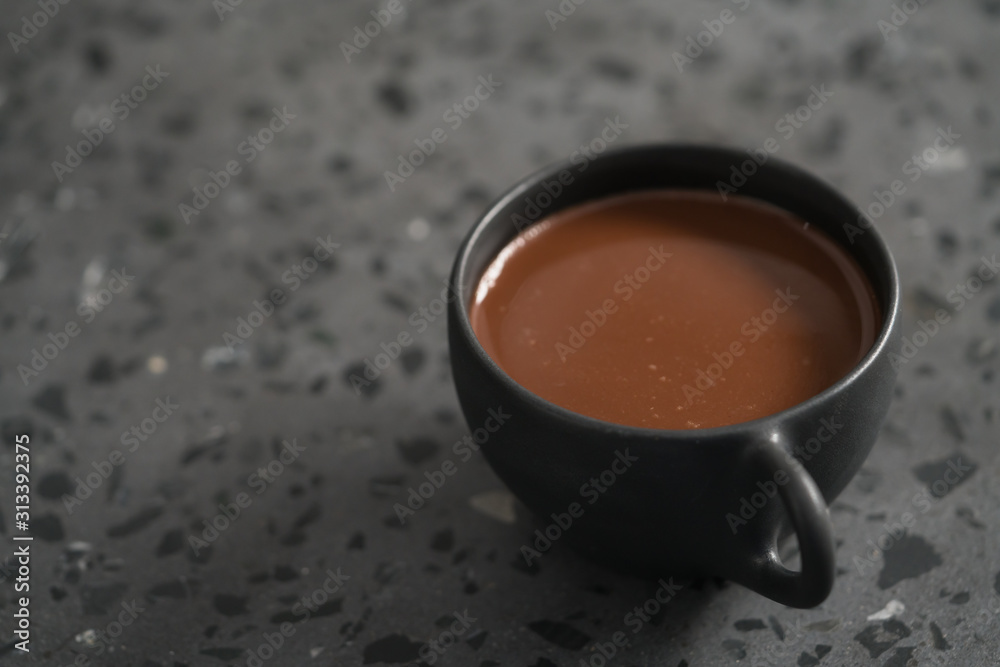 Wall mural simple cup of hot chocolate drink on terrazzo background