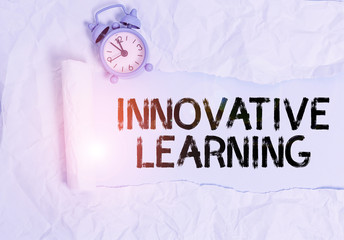 Handwriting text writing Innovative Learning. Conceptual photo Interdisciplinary teaching that stirs analytic thinking Alarm clock and torn cardboard placed above plain pastel table backdrop