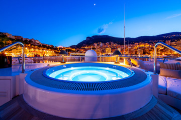 Luxurious Nightlife: Jacuzzi on Charter Yacht Deck in Monaco Port - obrazy, fototapety, plakaty
