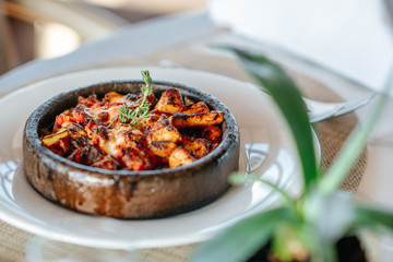 A delicious spicy chicken casserole with rice is served in a elegance restaurant or hotel