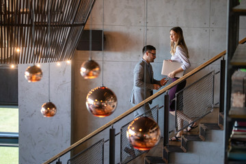 Beautiful business colleagues at meeting in modern office interior