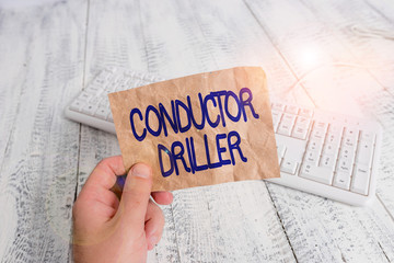 Writing note showing Conductor Driller. Business concept for means of conveying the upflowing drilling fluid Man holding colorful reminder square shaped paper wood floor