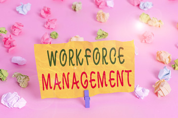 Fototapeta na wymiar Handwriting text writing Workforce Management. Conceptual photo use to optimize the productivity of its employees Colored crumpled papers empty reminder pink floor background clothespin