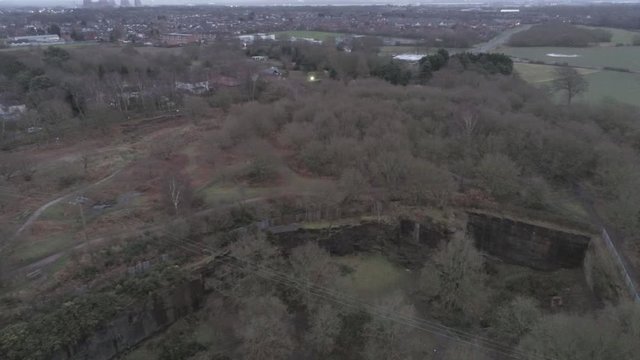 Pex hill aerial view orbit above woodland quarry parkland walk. Dense woodland countryside farmland landscape.