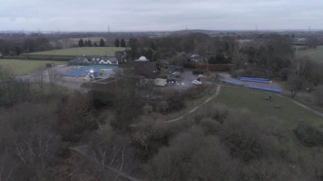 Aerial view across Pex Hill woodland walking trail &  Leighton Observatory silver dome building. Push in to slight dolly left.