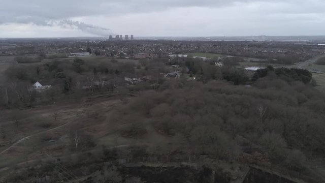 Pex hill woodland quarry parkland walk. Aerial view pull back above dense woodland countryside farmland landscape.