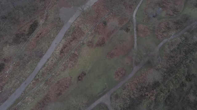 Pex hill woodland quarry parkland walk. Dense woodland countryside farmland landscape. Birds eye to tilt up power station horizon.