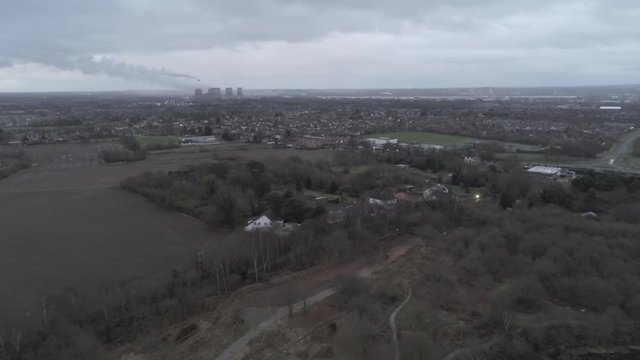 Pex hill woodland quarry parkland walk. Dense woodland countryside farmland landscape. Tilt down from power station horizon.