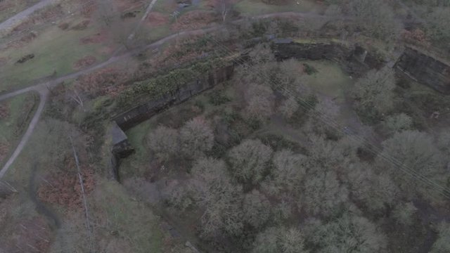 Pex hill woodland quarry parkland walk. Dense woodland countryside farmland landscape. Birds eye orbit  to tilt up horizon.