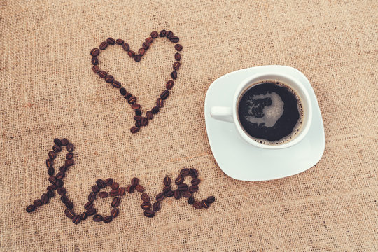 A vintage image for showing the love with coffee beans and a cup of cofee.