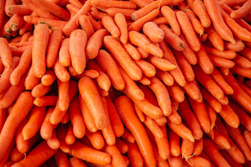 Beautiful selected organic carrot background, ripe carrot for preparing meal, lots of washed carrots on a market counter.
