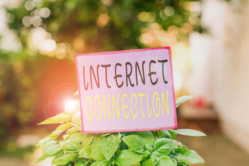 Conceptual hand writing showing Internet Connection. Concept meaning The way one gains access or connection to the Internet Plain paper attached to stick and placed in the grassy land