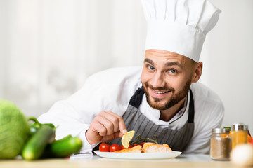 Chef Cooking Roasted Salmon Steak Plating Dish Standing In Kitchen