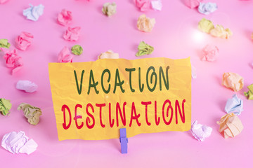 Obraz na płótnie Canvas Handwriting text writing Vacation Destination. Conceptual photo a place where showing go for holiday or relaxation Colored crumpled papers empty reminder pink floor background clothespin