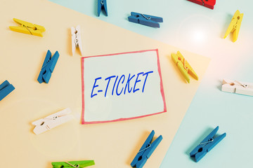 Word writing text E Ticket. Business photo showcasing Digital ticket that is as valid as a paper ticket or its equivalent Colored clothespin paper empty reminder yellow blue floor background office
