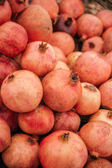 Beautiful selected organic pomegranate background, ripe red an sweet pomegranate, lots of pomegranate on a market counter.
