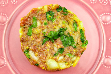 Beef Tartare cold appetizer of raw minced meat with egg yolk, spices, onions, olive oil, lemon juice