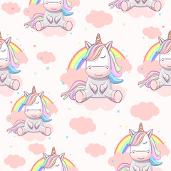 Seamless pattern with unicorn on the clouds with a rainbow. © babysofja