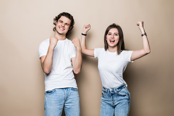 Portrait of attractive lovely couple wearing checked shirt celebrating sport winning championship...