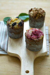 delicious cupcakes on wooden butcher 