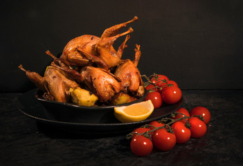 Fried stuffed quail on a dark table. Copy space