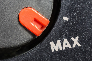 Macro close up view of vintage tape machine volume dial set to MAX.  