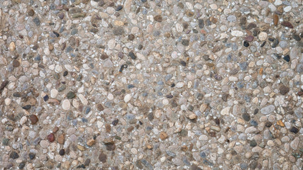 Pebble in concrete path. Top view stone background. Stone paving surface.