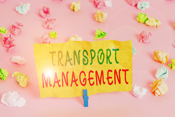 Handwriting text writing Transport Management. Conceptual photo analysisaging aspect of vehicle maintenance and operations Colored crumpled papers empty reminder pink floor background clothespin