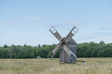 Fototapeta premium Grain mill on the summer landscape. Windmill and natural background pattern. Hiiumaa, small island in Estonia. Europe