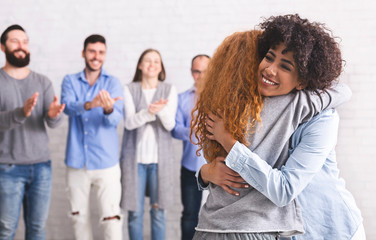 Happy patients embracing during support group session