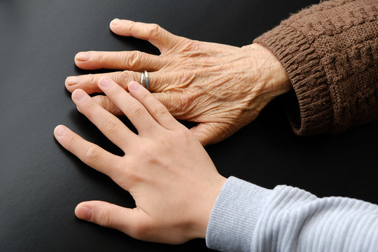 Old Woman's Hand And Young Man Touching Her Mercifully,