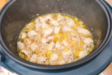 Stew is cooked in a slow cooker in its own juice.