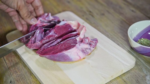 Chef cooking a fresh pig heart from market on wooden cutting board in kitchen for make a food have a pig heart for ingredient in restaurant