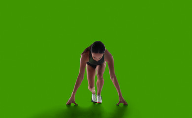 Female athlete isolated on green screen.